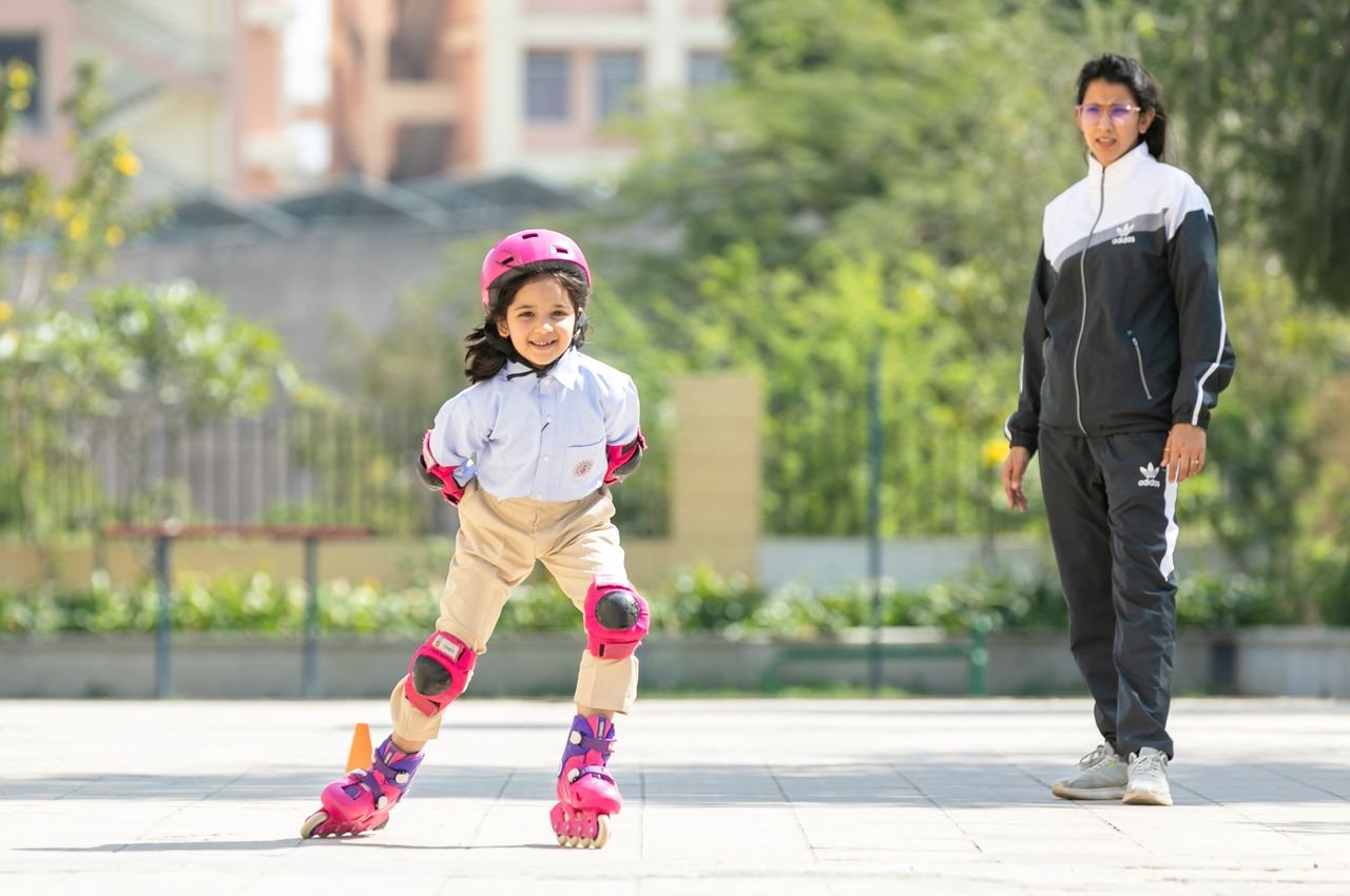Crafting Captivating Headlines: Your awesome post title goes here Child roller skating while supervised by an adult in a sunny outdoor setting.